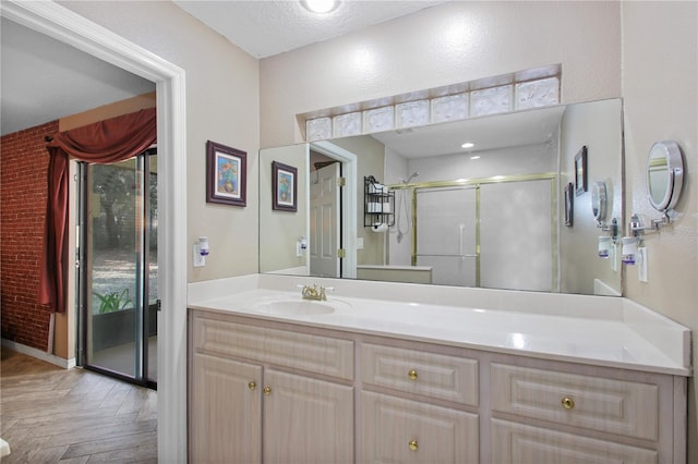 full bathroom with a stall shower and vanity