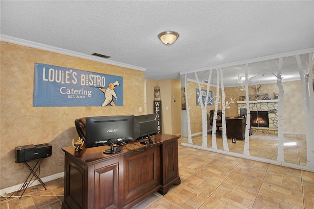 office area with a fireplace, visible vents, ornamental molding, a textured ceiling, and baseboards