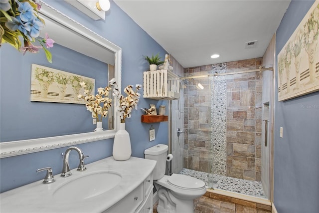 full bath featuring toilet, a shower stall, visible vents, and vanity