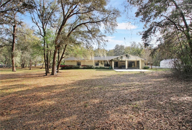 view of yard with a carport and a sunroom