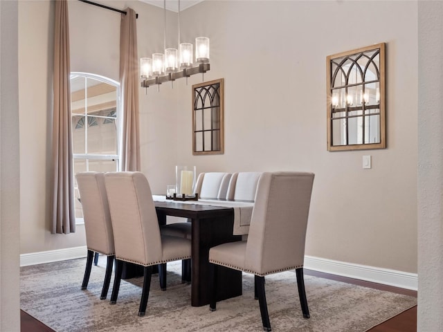 dining area featuring baseboards and wood finished floors