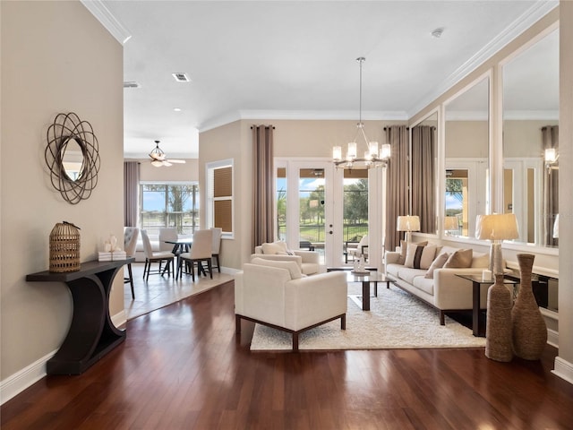 living room featuring a chandelier, dark wood-type flooring, and ornamental molding