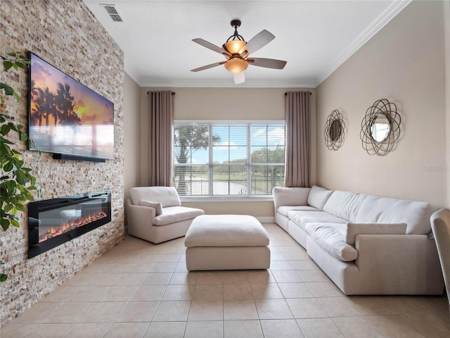 living area with visible vents, ceiling fan, ornamental molding, light tile patterned floors, and a fireplace