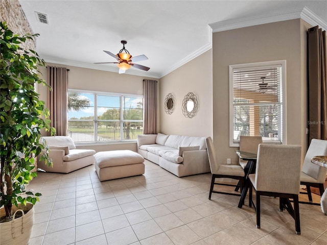 living room featuring light tile patterned floors, visible vents, a ceiling fan, and ornamental molding