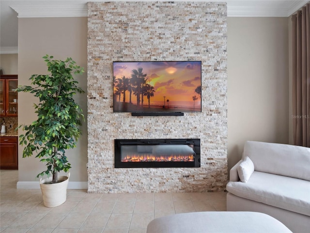 living area with a stone fireplace, crown molding, and tile patterned flooring