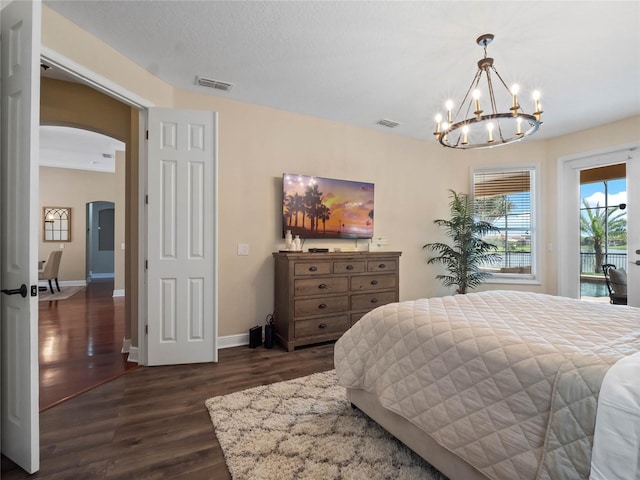 bedroom featuring visible vents, baseboards, access to outside, arched walkways, and dark wood-style flooring