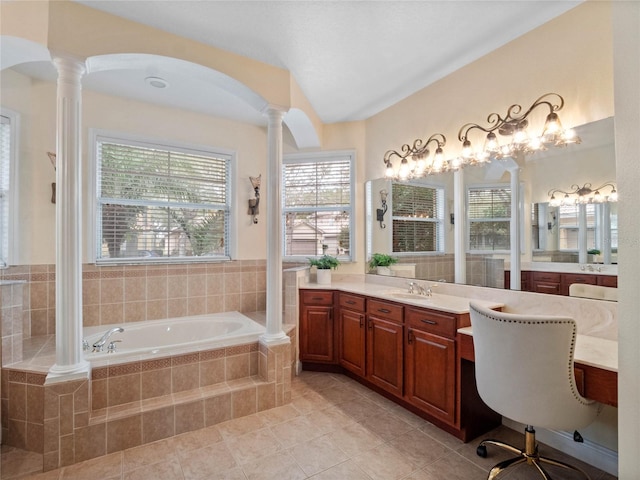 bathroom featuring tile patterned flooring, vanity, decorative columns, and a bath