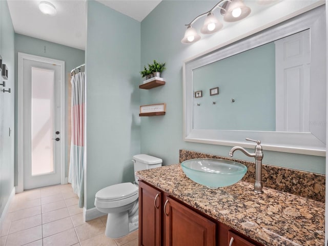 full bath featuring tile patterned flooring, toilet, vanity, and baseboards