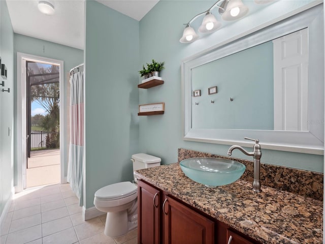 full bathroom with a shower with curtain, toilet, tile patterned flooring, baseboards, and vanity