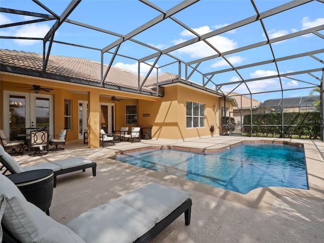 outdoor pool with ceiling fan, a lanai, french doors, an outdoor hangout area, and a patio