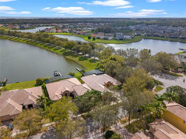 drone / aerial view with a residential view and a water view