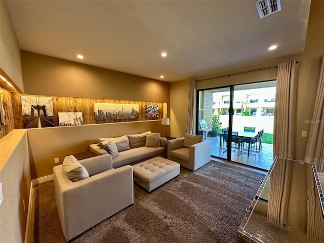 carpeted living room with visible vents and recessed lighting