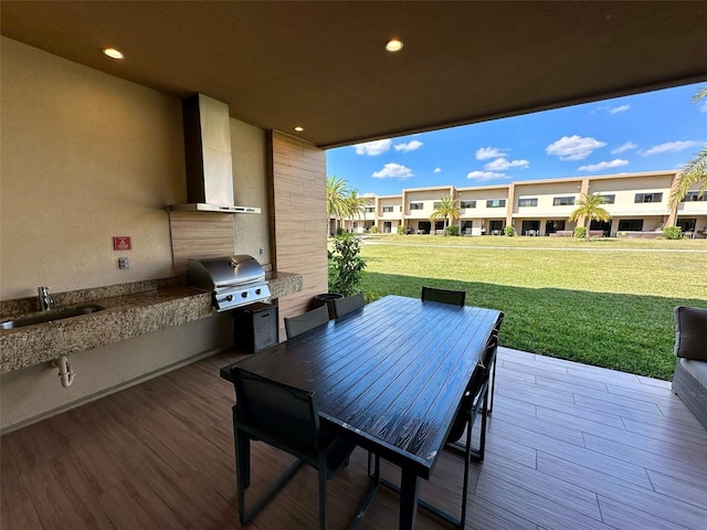 view of patio featuring grilling area, area for grilling, outdoor dining space, a sink, and a residential view