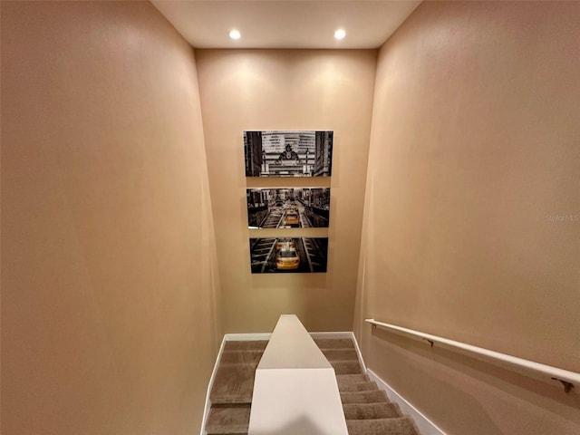 stairway with baseboards and recessed lighting