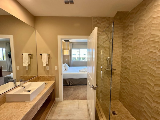 ensuite bathroom featuring a wealth of natural light, visible vents, a walk in shower, and connected bathroom