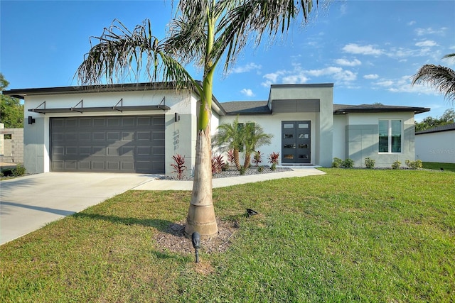 view of front of property featuring a garage, concrete driveway, french doors, a front yard, and stucco siding