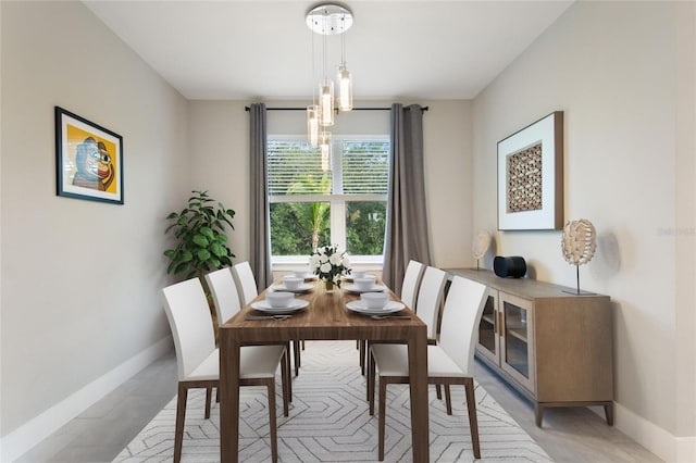 dining area with a chandelier and baseboards