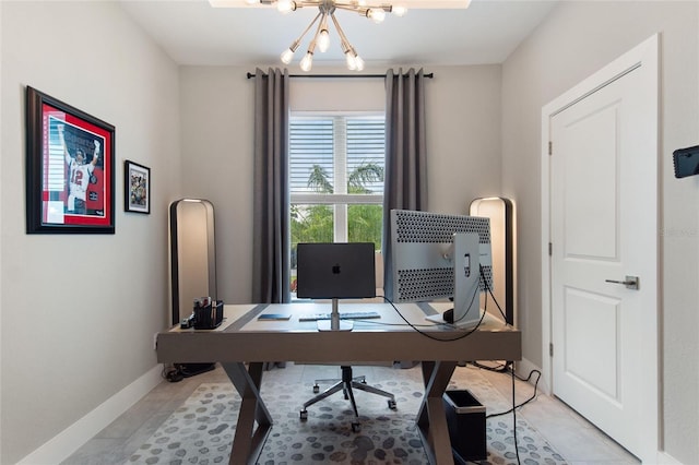 office featuring baseboards and a chandelier