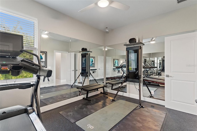 workout room with ceiling fan, visible vents, and baseboards