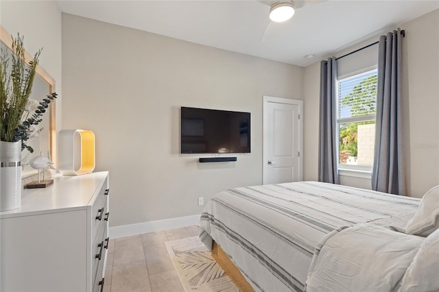 bedroom featuring light tile patterned floors, ceiling fan, and baseboards