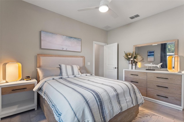 bedroom featuring light tile patterned floors, ceiling fan, and visible vents