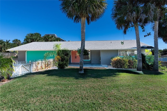 ranch-style house featuring a front lawn, fence, a gate, and stucco siding