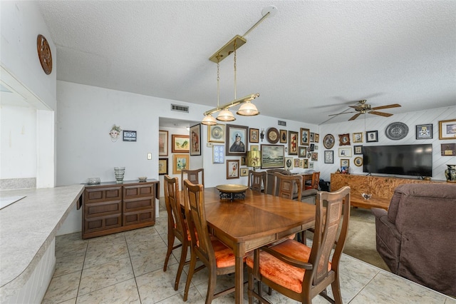 dining area with a ceiling fan, visible vents, a textured ceiling, and light tile patterned floors