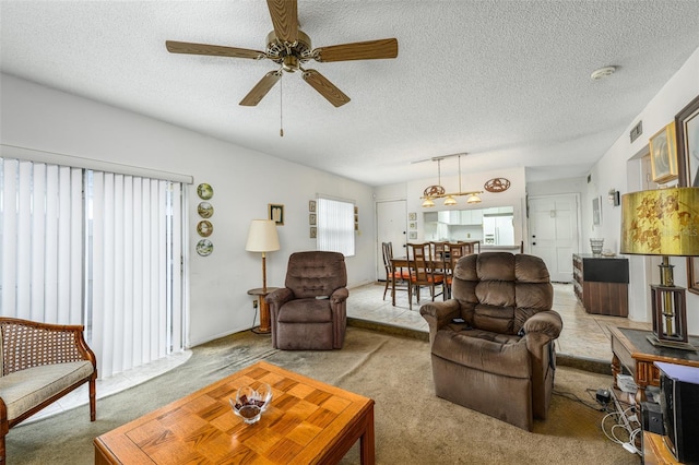 living room featuring visible vents, a textured ceiling, and light colored carpet