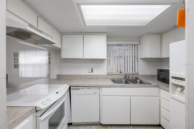 kitchen featuring light countertops, white appliances, a sink, and white cabinetry