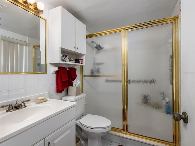 full bathroom with tile walls, toilet, decorative backsplash, a stall shower, and vanity