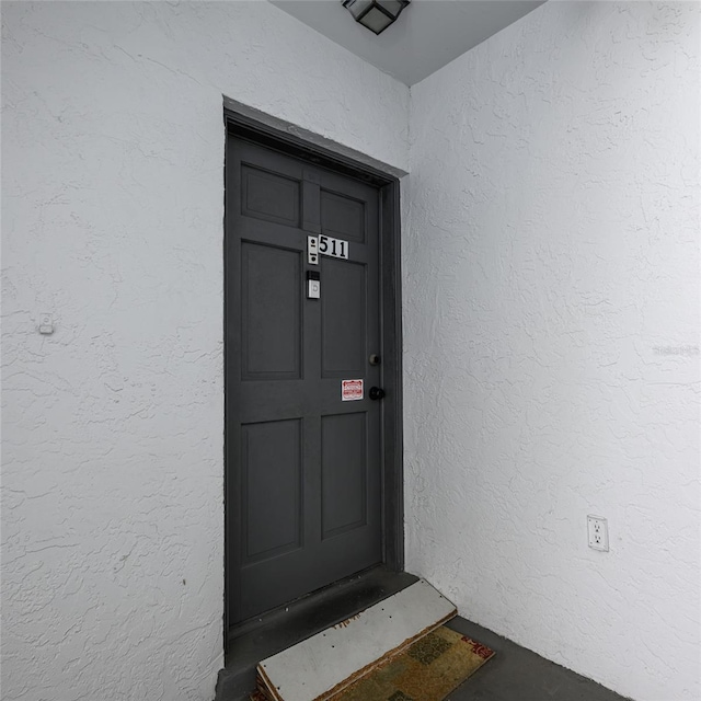 view of exterior entry featuring stucco siding