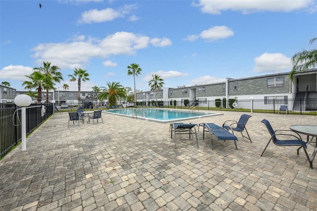 community pool featuring a patio area and fence