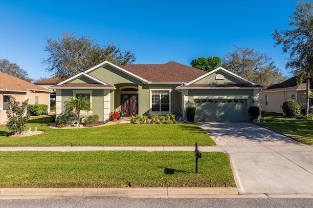 ranch-style home featuring stucco siding, driveway, an attached garage, and a front lawn