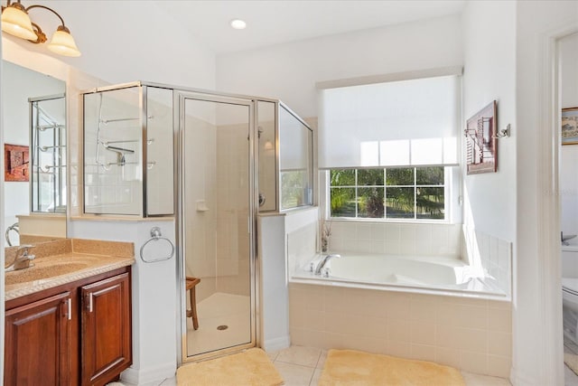 full bath with tile patterned flooring, a shower stall, toilet, a garden tub, and vanity