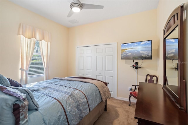 bedroom featuring visible vents, a ceiling fan, a closet, carpet floors, and baseboards