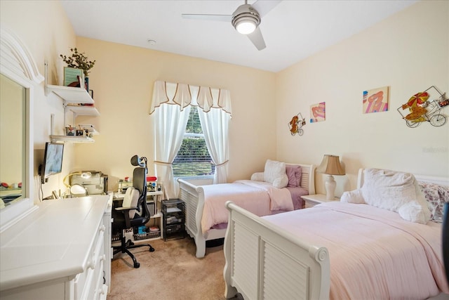 bedroom with a ceiling fan and light carpet