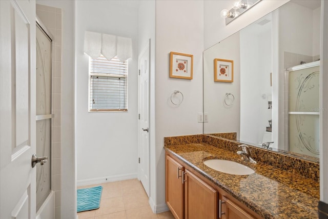 bathroom with tile patterned flooring, visible vents, a shower stall, baseboards, and vanity