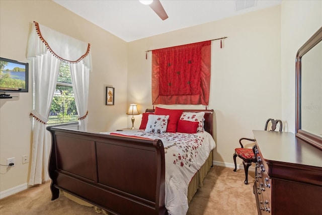 bedroom featuring light carpet, visible vents, a ceiling fan, and baseboards