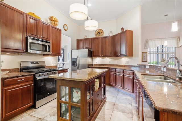 kitchen with light stone countertops, ornamental molding, hanging light fixtures, a sink, and appliances with stainless steel finishes