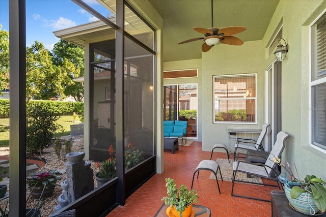 sunroom featuring ceiling fan