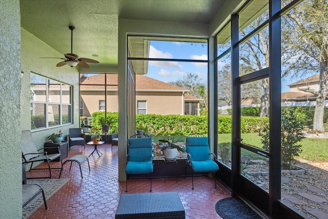 sunroom featuring ceiling fan