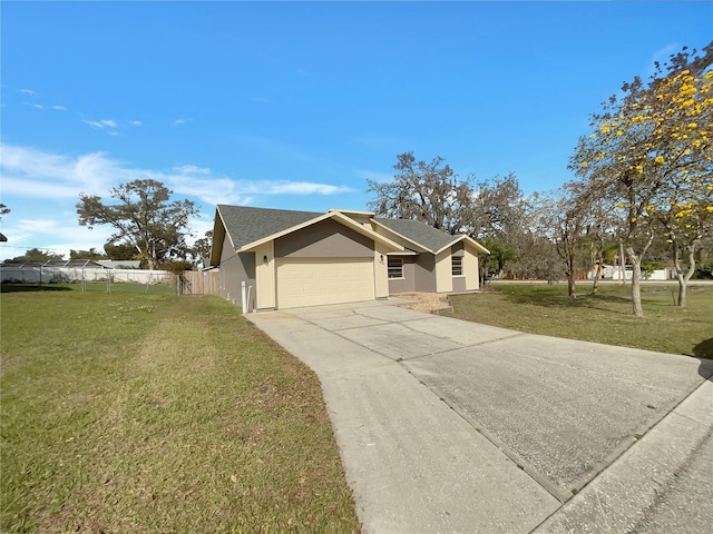 view of front of house featuring a garage, driveway, fence, a front lawn, and stucco siding