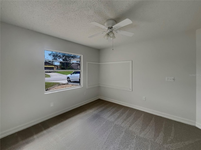 empty room featuring a ceiling fan, a textured ceiling, and baseboards