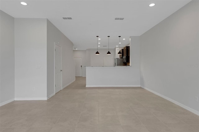 unfurnished living room with visible vents and recessed lighting