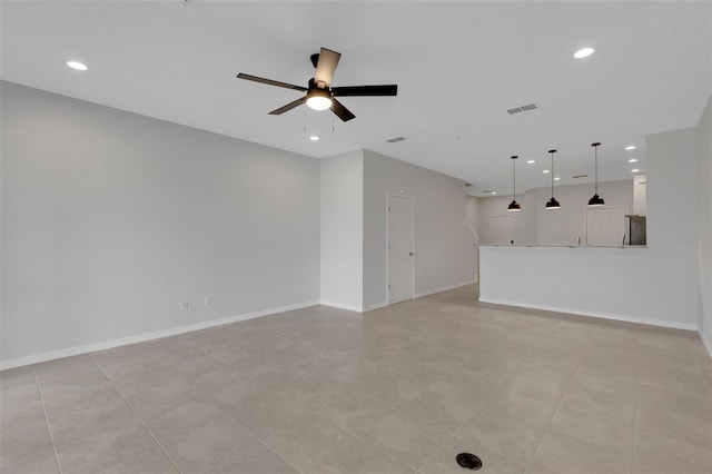 spare room with a ceiling fan, recessed lighting, visible vents, and baseboards