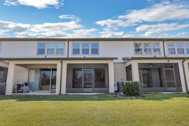 back of property featuring a sunroom and a yard