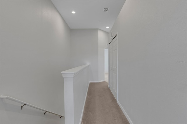 hall featuring light carpet, visible vents, baseboards, an upstairs landing, and recessed lighting