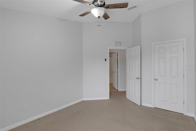 unfurnished bedroom featuring visible vents, light carpet, and baseboards