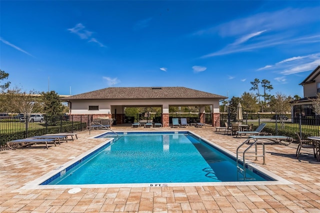 community pool featuring a patio and fence