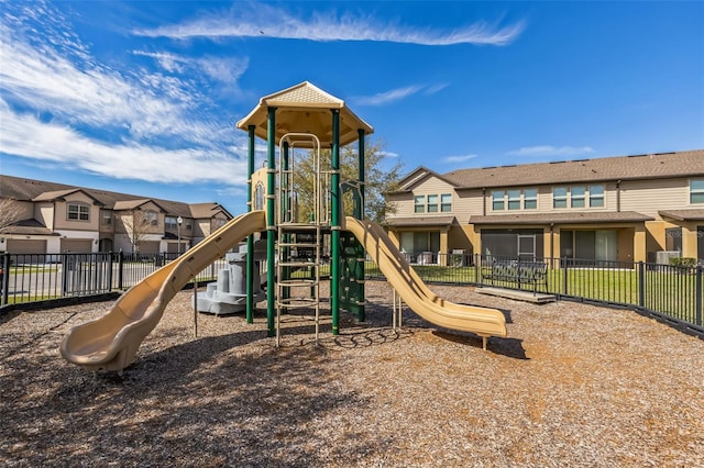 communal playground with a residential view and fence